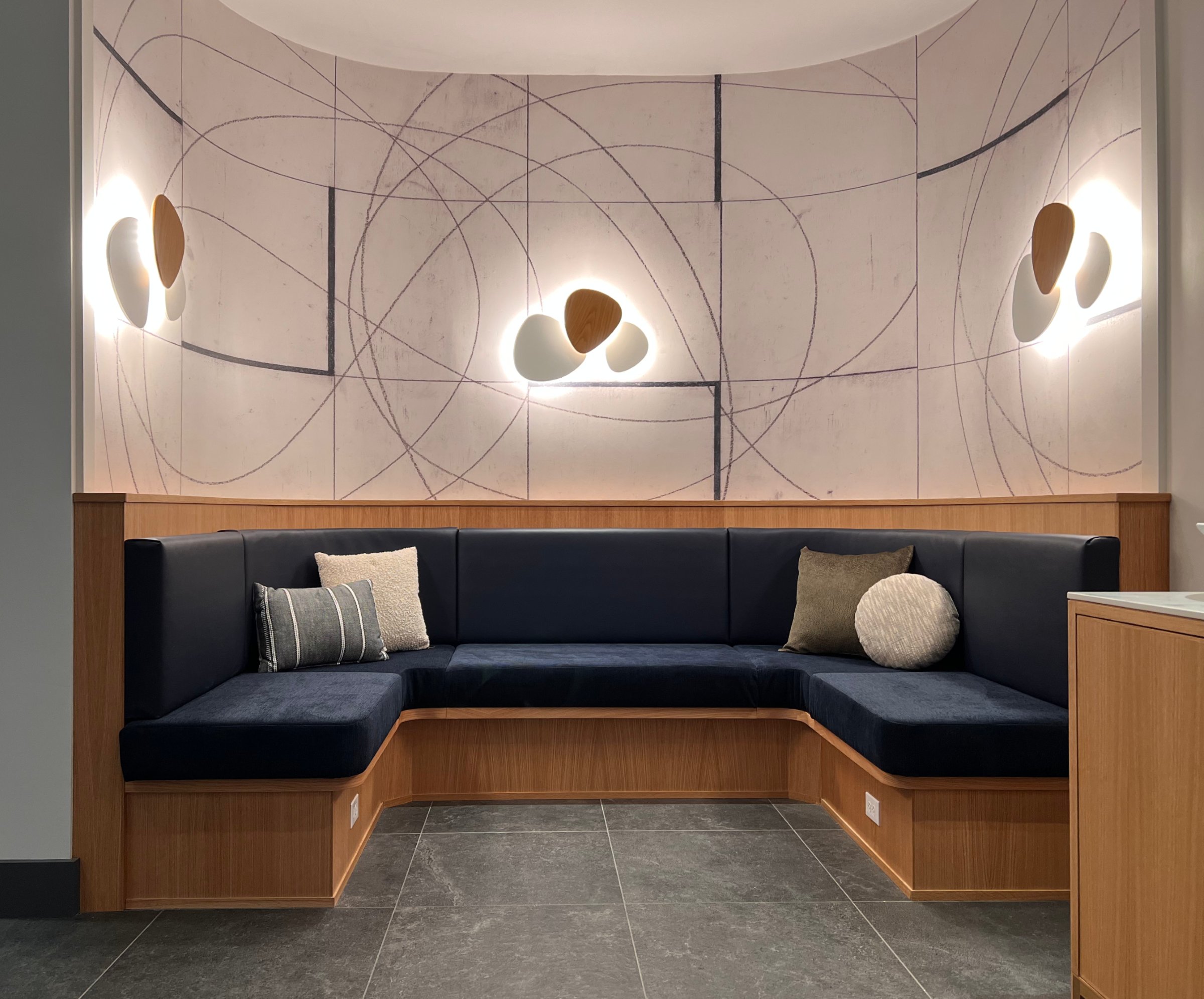 Commercial banquette seating with sculptural wall sconces